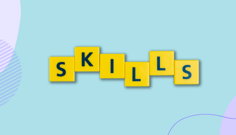 Yellow scrabble tiles that spell the word 'skills' on a mint green background.
